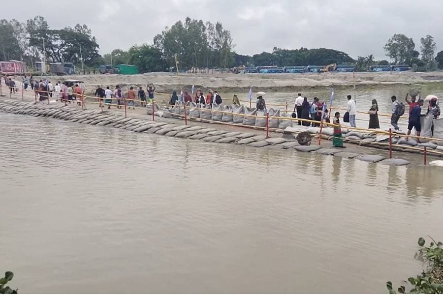 Rising Padma water floods Paturia Launch Ghat access road